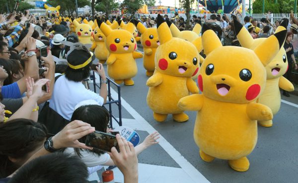 Performers dressed as Pikachu, the popular animation Pokemon series character, perform in the Pikachu parade in Yokohama on August 7, 2016. Some 50 life-size Pikachu characters, the most famous from the Pokemon game, marched along the city's waterfront street as visitors took mobile phone pictures and videos of them in scorching sunshine. / AFP PHOTO / KAZUHIRO NOGI